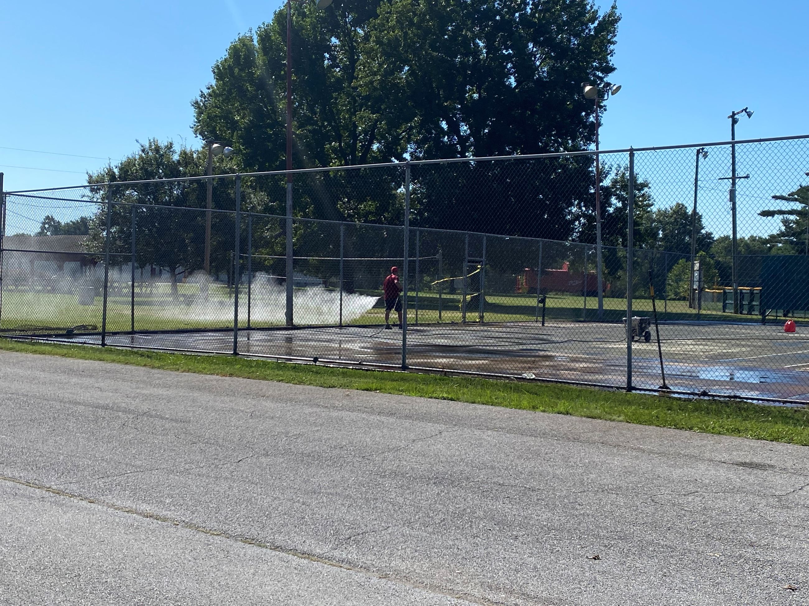 Basketball and tennis courts in the park being resurfaced
